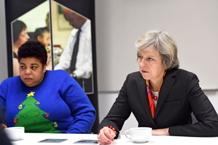 Prime Minister Theresa May (right) with Maxine Thomas, a support worker at Robertson Street Hostel during her visit to Thames Reach Employment Academy centre, South East London.