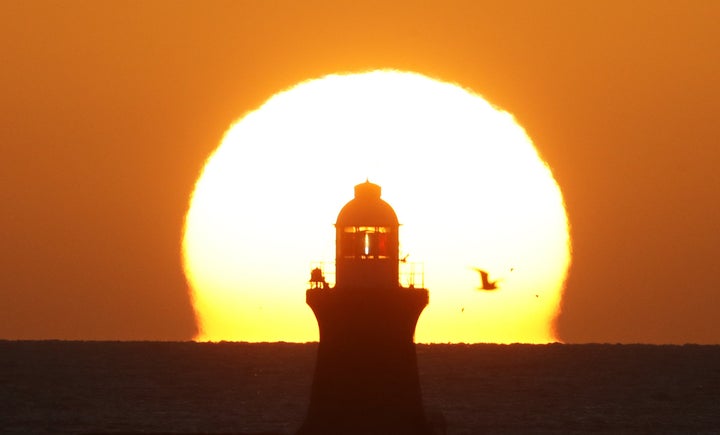 The sun rises over South Shields Lighthouse on the North East coast, as Britain braced itself for the arrival of Storm Barbara, which is set to batter the country with strong winds.