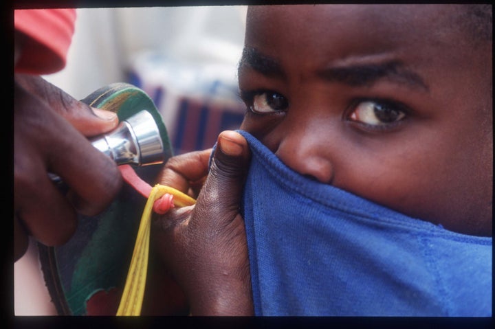 A child covers his face as a defence against the Ebola virus in Zaire 