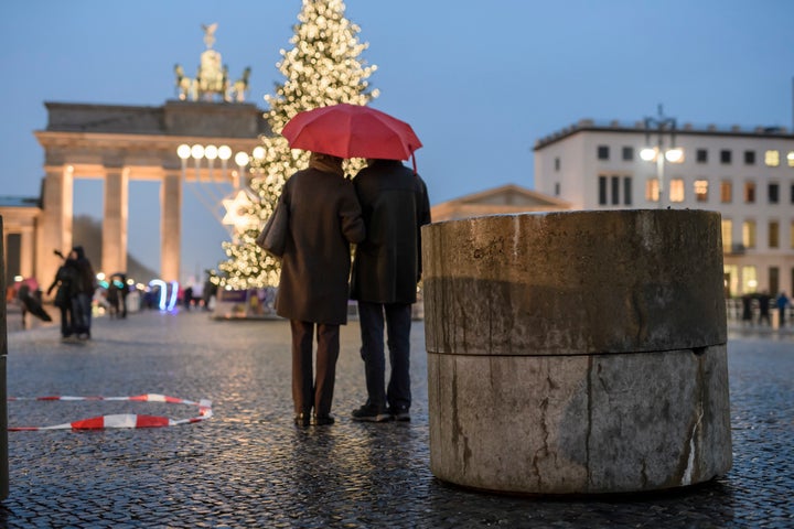 A concrete barricade stands near the Brandenburg Gate in Berlin.