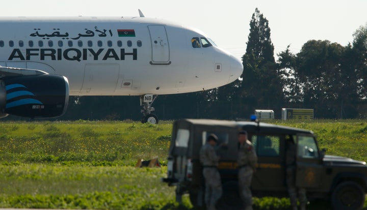 Maltese troops survey a hijacked Libyan Afriqiyah Airways Airbus A320 on the runway at Malta Airport