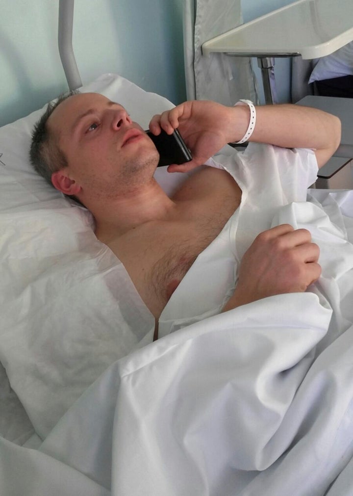 Cristian Movio, the Milan policemen who shot dead the suspect in the Berlin Christmas market truck attack, talks on a mobile phone as he lies injured in a hospital bed in Milan.