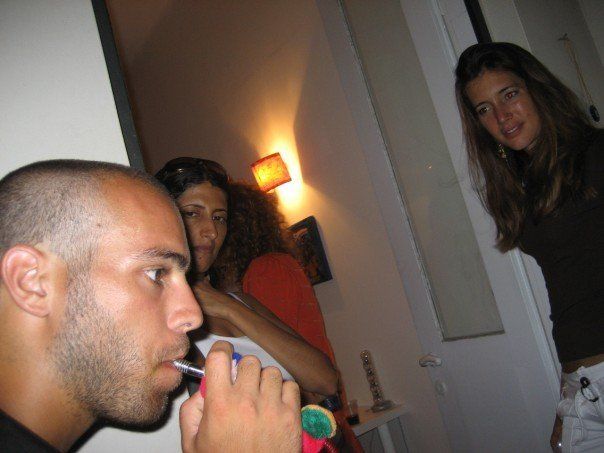 Smoking a water pipe, at a social gathering of locals and expatriates in Tel Aviv, Israel, in 2007.