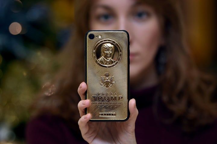 An employee of Caviar Phones shows off a more affordable version of a gold-plated Trump smartphone.