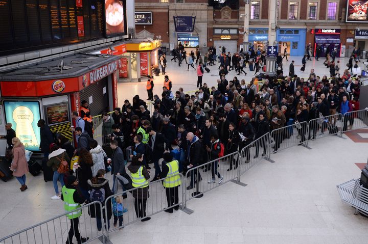 Passengers queue for trains to Gatwick Airport at London's Victoria Station on the third day of strikes on Southern this week