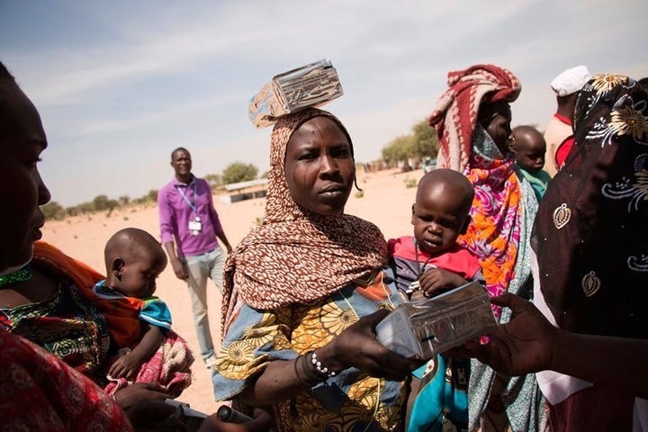 Women gather to collect aid at the Dar es Salaam refugee camp in Chad, close to the border to Niger.