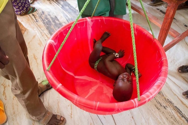 An infant is weighed at the Dar es Salaam refugee camp.