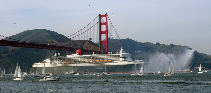 The Queen Mary 2 moves beneath the Golden Gate Bridge as it enters a harbor in San Francisco, California February 4, 2007.