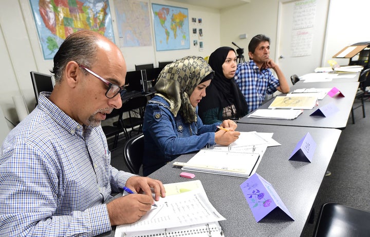 Syrian refugees take notes during their Vocational ESL class at the International Rescue Committee center in San Diego on August 31, 2016.