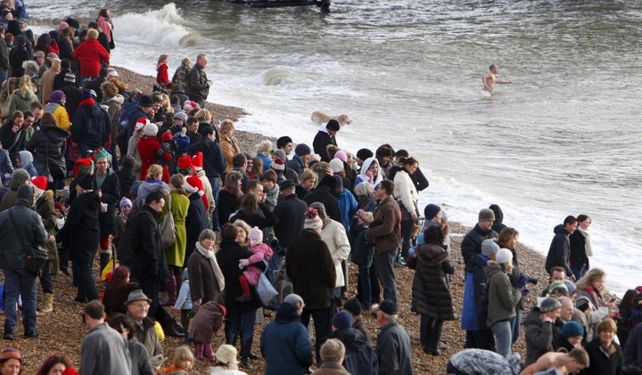 Spectators gather on the beach to watch the few dozen foolhardy swimmers on Christmas Day