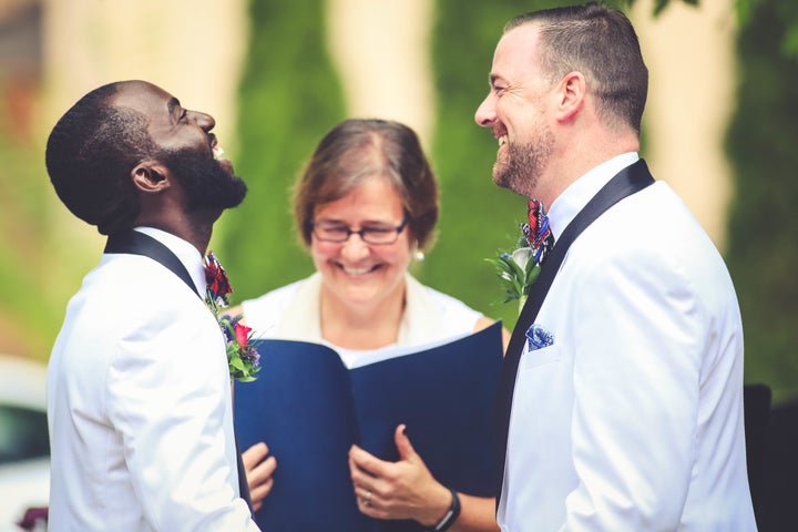 <p>Eric and David share a laugh during their July 2016 wedding ceremony. </p>