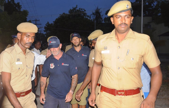 Indian policemen escort crew members of a U.S.-owned ship MV Seaman Guard Ohio outside a court in Tuticorin, in the southern Indian state of Tamil Nadu in October 2013.