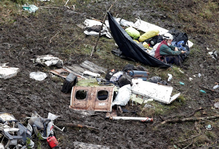 A rescue worker sits near the wreckage of a plane that crashed into the Colombian jungle with Brazilian soccer team Chapecoense onboard near Medellin, Colombia, November 29, 2016.