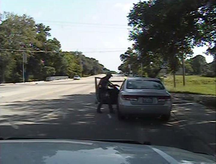 Texas state trooper Brian Encinia points a Taser, in this still image captured from the police dash camera video from the tra