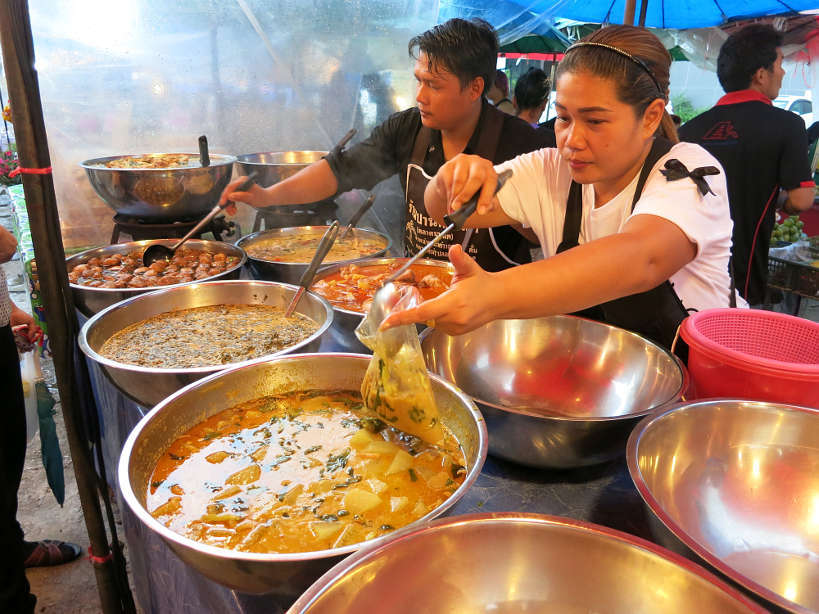 Food vendor selling curries at Sathorn market
