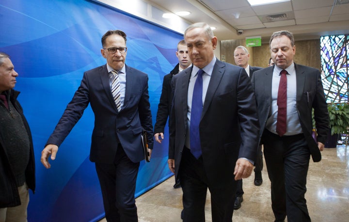 Israeli Prime Minister Benjamin Netanyahu (C) arrives for the weekly cabinet meeting in Jerusalem on December 25, 2016.