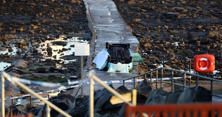 A car on its roof lies on the causeway at St Mary's Lighthouse, Whitley Bay, North Tyneside following the accident where the driver died.