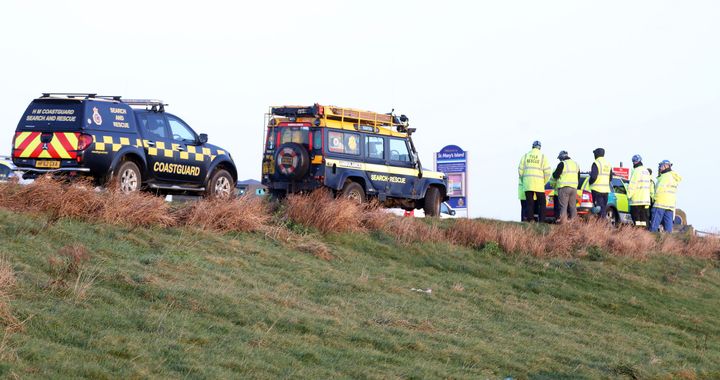 Coastguard in attendance as a car on its roof lies on the causeway at St Mary's Lighthouse, Whitley Bay.