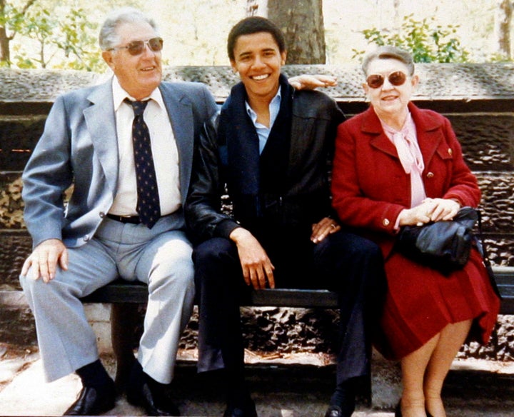 A young Barack Obama sits with his grandparents Stanley and Madelyn Dunham. 