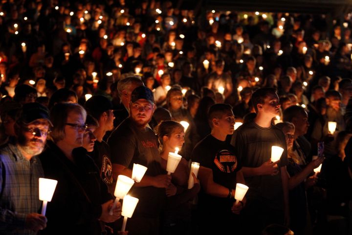 People take part in a candlelight vigil following the mass shooting at Umpqua Community College in Roseburg, Oregon.