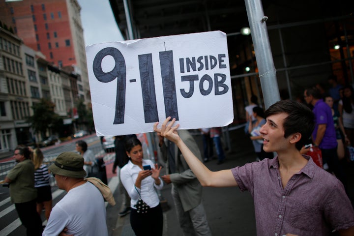 A man holds up a placard as sign of protest near to the scene of an explosion on West 23rd Street September, 18, 2016 in New York.