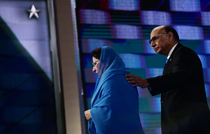 Ghazala Khan (L), accompanied by her husband Khizr Khan (R), walks off stage on the final night of the Democratic National Convention at the Wells Fargo Center, July 28, 2016 in Philadelphia, Pennsylvania.