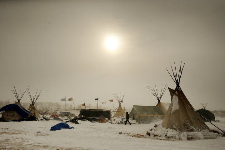 A camper walks through high winds during a blizzard inside the Oceti Sakowin camp as "water protectors" continue to demonstra