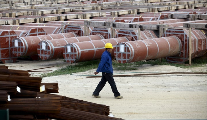 A Chinese worker walks at the construction site of the new Great Mosque, which is being built by the China State Construction Engineering Corporation (CSCEC), in Algiers, Algeria on Jan. 20, 2016.