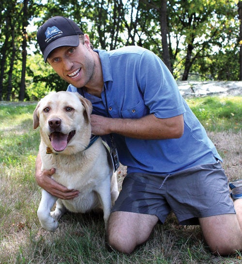 Jordan and his current dog, Kariya, a playful English yellow lab