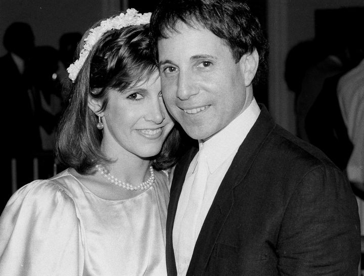 Carrie Fisher and Paul Simon pose together in 1983.