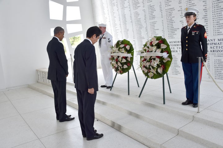 President Barack Obama and Japanese Prime Minister Shinzo Abe place wreaths at the USS Arizona Memorial at Pearl Harbor in Ho