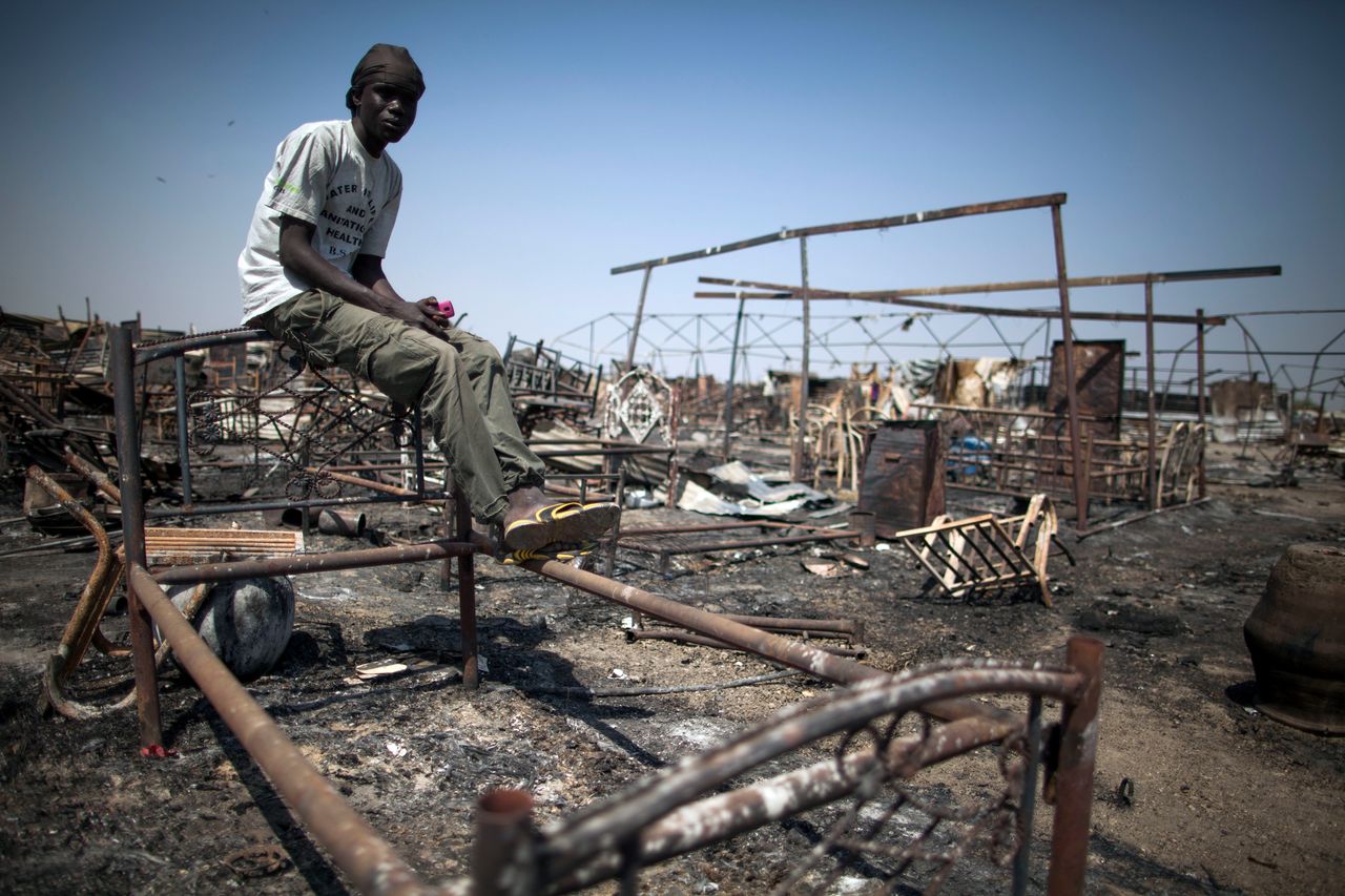 Shaggier Gabriel, a displaced man residing in the United Nations Protection of Civilians (PoC) site in Malakal, South Sudan, sits on his former bed in a burnt and looted area, on Feb. 26, 2016.