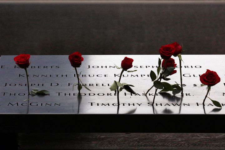 Roses are placed on names on the memorial during the ceremony marking the 15th anniversary of the attacks on the World Trade Center at The National September 11 Memorial and Museum in Lower Manhattan in New York City.