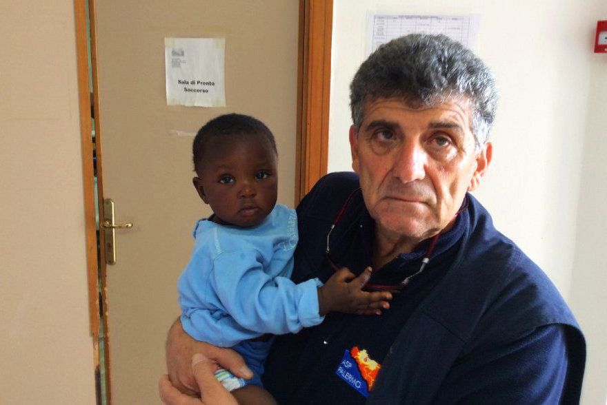 Bartolo holds a 9-month-old Nigerian girl named Favour.