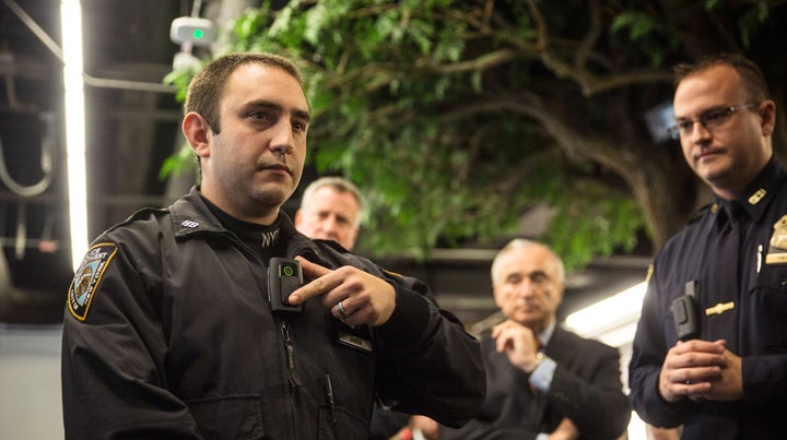 NYPD Officer Joshua Jones demonstrates how to use a body camera during a December 2014 press conference.