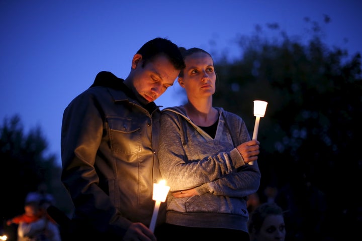 People take part in a candlelight vigil for victims of the Umpqua Community College shooting in Oregon on Oct. 3, 2015.