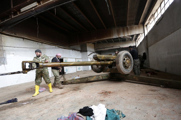 Rebel fighter clean a weapon in al-Rai town, northern Aleppo countryside, Syria December 25, 2016.