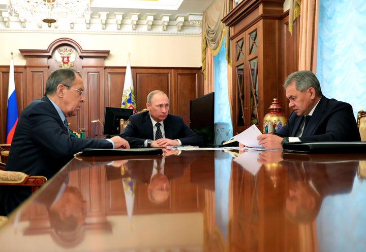 Russia's President Vladimir Putin (C), Foreign Minister Sergei Lavrov (L), and Defence Minister Sergei Shoigu attend a meeting at the Kremlin in Moscow.