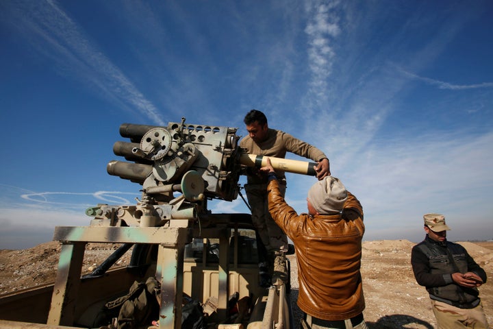 Iraqi army personnel reload ammunition during clashes with Islamic State militants, north of Mosul, Iraq, December 29, 2016.