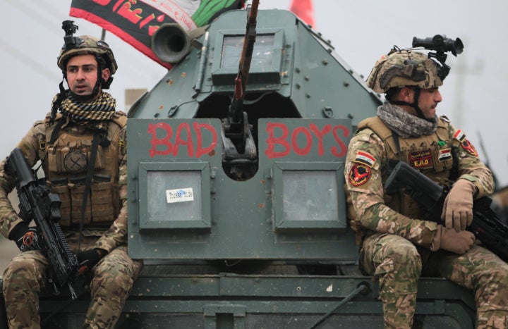 Iraqi pro-government forces patrol the eastern part of the embattled Iraqi city of Mosul on December 28, 2016.