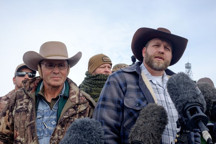 Ammon Bundy, right, leader of a group of armed anti-government protesters speaks to the media as other members look on at the Malheur National Wildlife Refuge near Burns, Oregon on January 4, 2016.