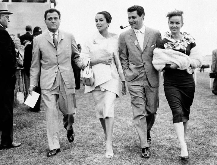 Mike Todd, Elizabeth Taylor, Eddie Fisher and Debbie Reynolds stroll through Epsom Downs on June 5, 1957.