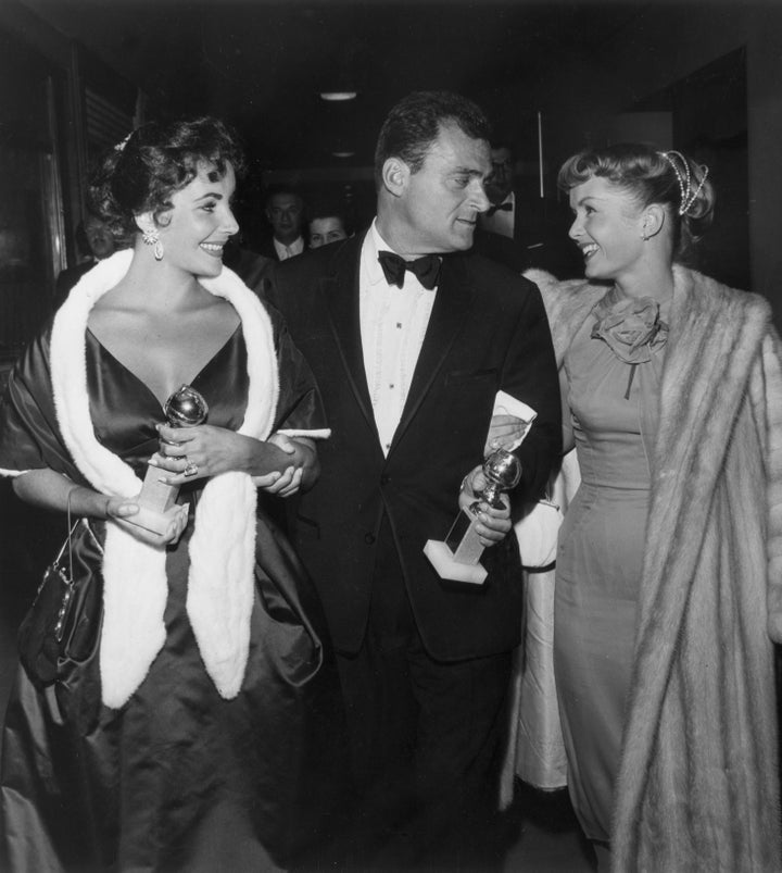 Elizabeth Taylor, Mike Todd and Debbie Reynolds attend the 1958 Golden Globe Awards.