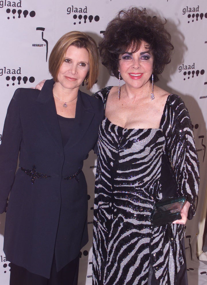 Carrie Fisher and Elizabeth Taylor pose at the 2011 GLADD Awards.