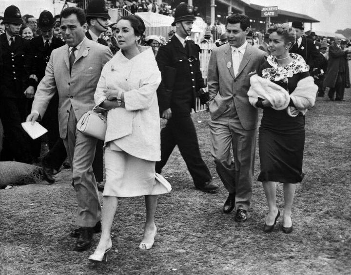 Mike Todd, Elizabeth Taylor, Eddie Fisher and Debbie Reynolds stroll through Epsom Downs on June 5, 1957.