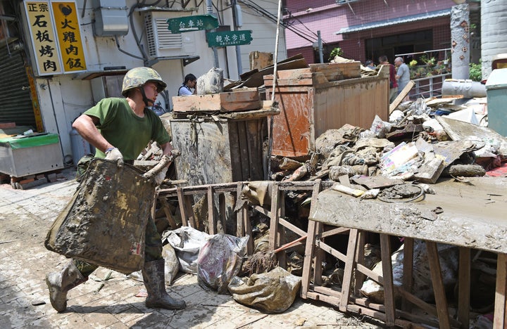 A military soldier helps clearing up debris in Wulai, the New Taipei City, on August 11, 2015.