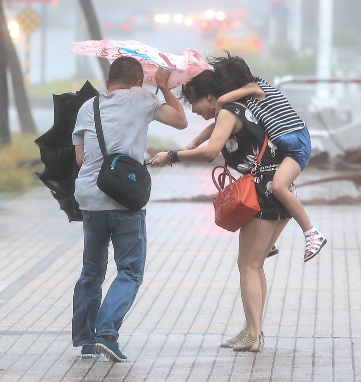 Citizens walk in the Typhoon Soudelor on August 8, 2015 in Kaohsiung, Taiwan of China.