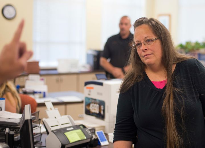 Kim Davis, the Rowan County Clerk of Courts, listens to Robbie Blankenship and Jesse Cruz as they speak with her about getting a marriage license at the County Clerk's Office on September 2, 2015 in Morehead, Kentucky.