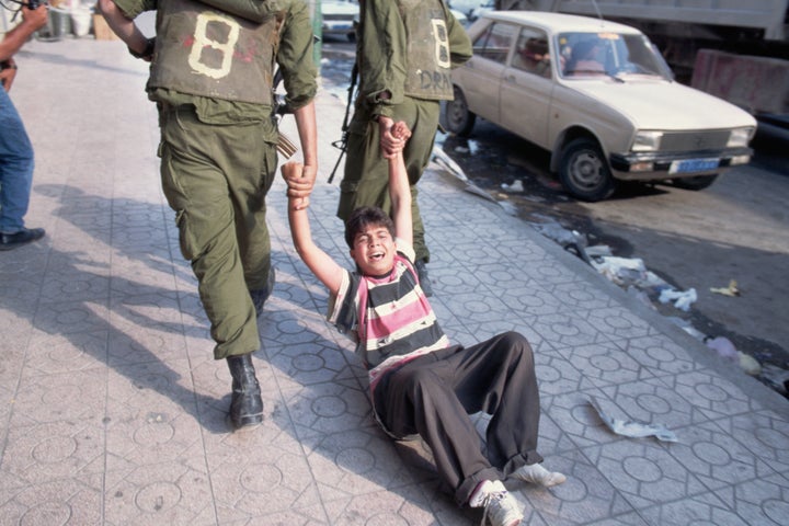 Israeli soldiers detain a Palestinian child following clashes in Hebron, West Bank. 