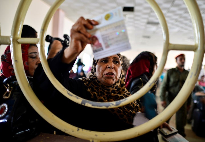 A Palestinian woman shows her identification card at a checkpoint at the border with Egypt on Sept. 7, 2016.